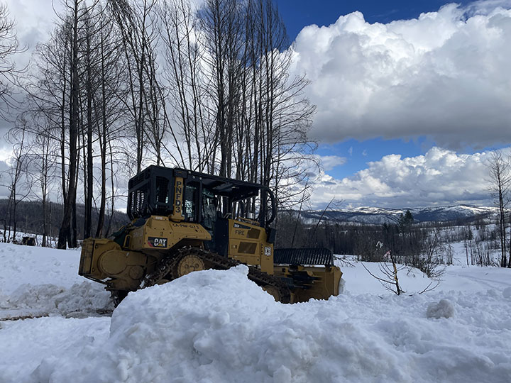 Feather River Ranger District dozer operated by a wildland firefighter clearing roads in the Milsap Bar area near Berry Creek to help get someone out.