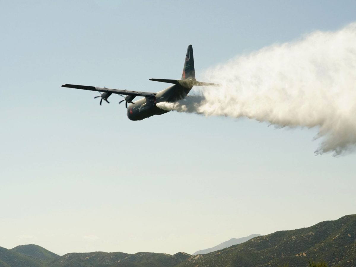 A U.S. Air National Guard MAFFS (Modular Airborne Fire Fighting System) equipped C-130J Super Hercules assigned to the 115th Airlift Squadron discharges a line of water simulating a fire retardant drop during aerial wildfire suppression training with the U.S. Forest Service and the California Department of Forestry and Fire Protection (CAL FIRE) in the mountains of the Angeles Forest above Santa Clarita, California, May 12, 2023.