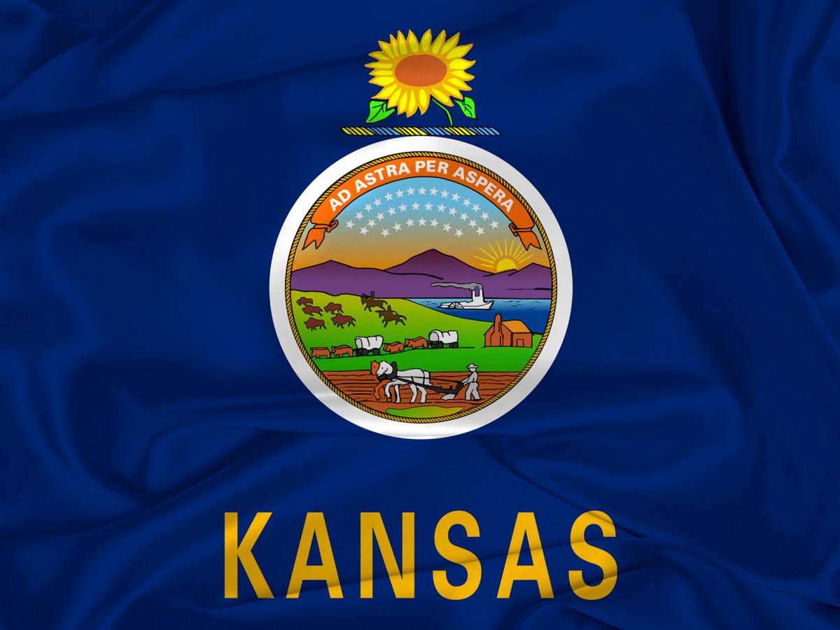 A Kansas state flag over silk texture