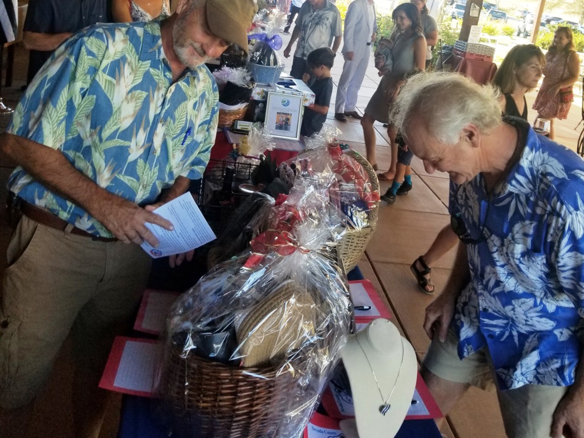 Guests at last year’s “Salute to First Responders” fundraiser look over donated items and gift certificates at the silent auction.